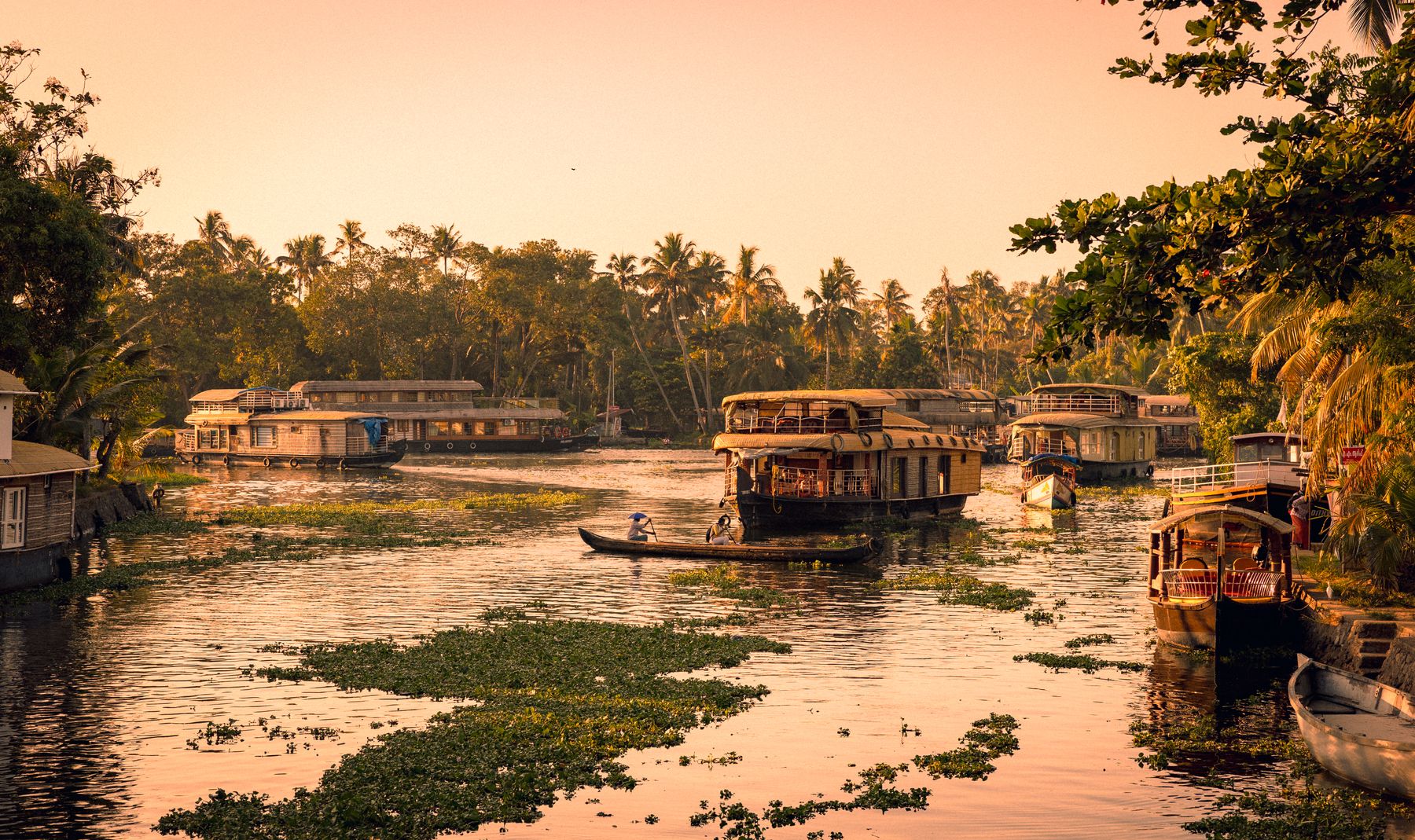 Canoers Row Past Kerala Houseboat